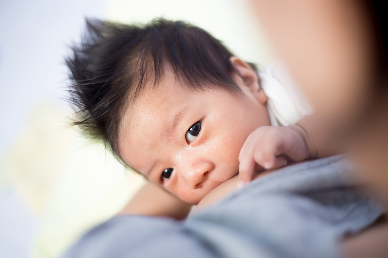 Breastfeeding baby with spiky black hair – Birth, Baby & You – Dee Bell – Lactation Consultant for Kent, Surrey & Sussex