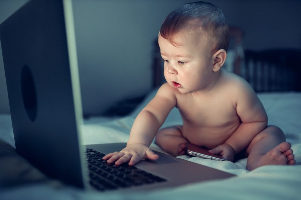 Baby with hand on laptop – Birth, Baby & You – Dee Bell – Lactation Consultant for Kent, Surrey & Sussex