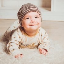 Baby crawling on fur rug – Birth, Baby & You – Dee Bell – Lactation Consultant for Kent, Surrey & Sussex
